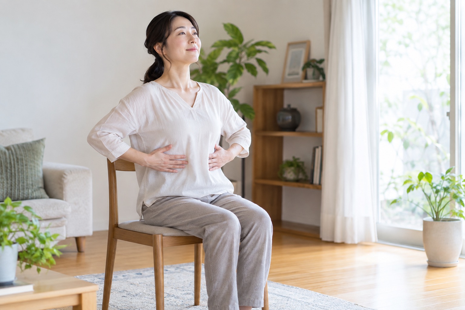 椅子に座ってお腹を圧迫せず穏やかに呼吸する女性